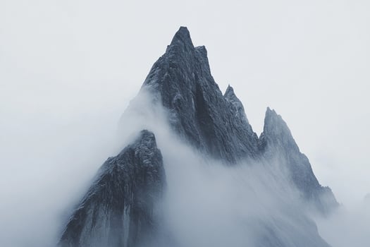 A mountain is covered in fog and snow photo