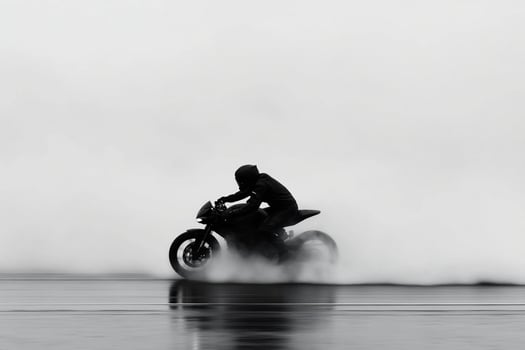 A person riding a motorcycle on a foggy day photo