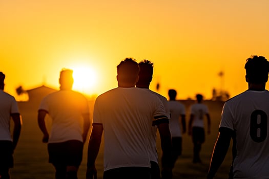 A group of men playing soccer in the sun photo