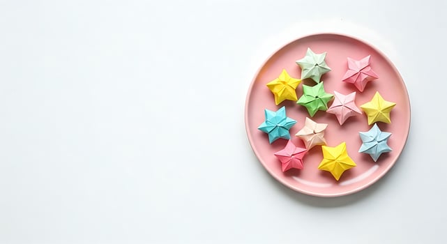 Colorful origami stars on a pink plate photo