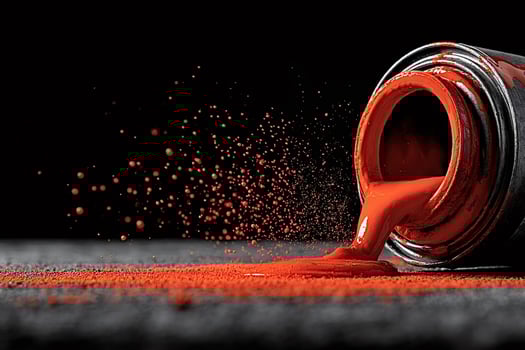 Red paint pouring from a can with splatter effect photo