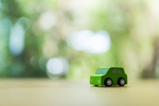 Green wooden toy car on wood table. photo