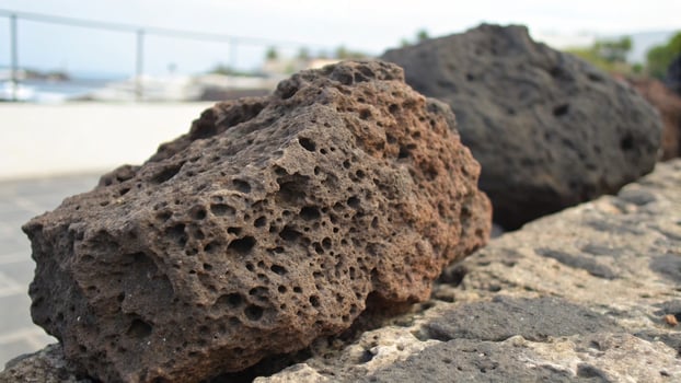 A large rock sitting on top of a wall photo