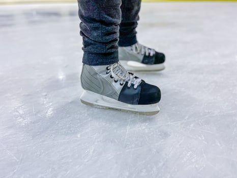 Ice skates standing on ice rink surface in winter sports activity photo
