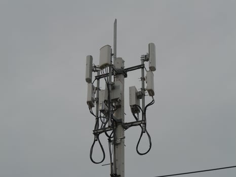 Telecommunication infrastructure installation urban setting technology structure cloudy atmosphere elevated perspective connectivity concept photo