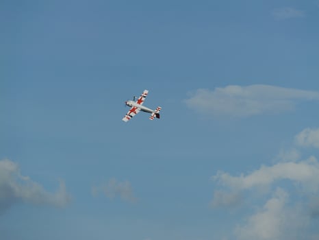 Aerial maneuver of a stunt plane open sky photography daytime high angle aviation excitement photo