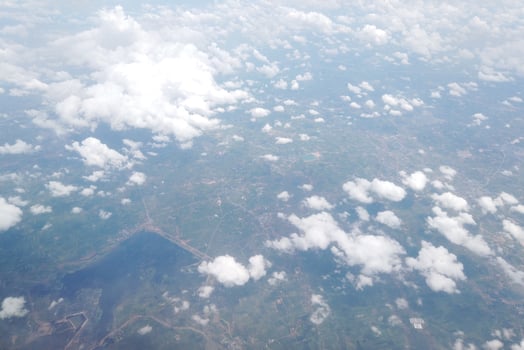 Aerial view of lush green landscape with clouds above rural area nature photography sky environment wide angle serenity photo