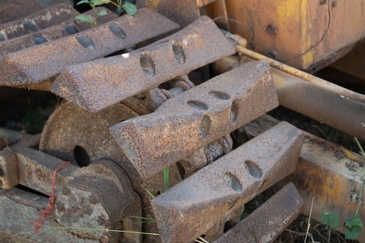 Heavy machinery action construction site close-up industrial environment ground level metal wear and tear photo