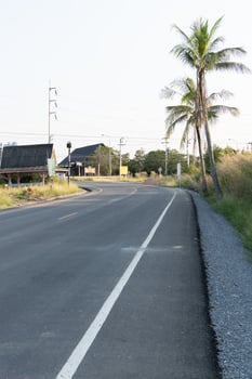 Scenic road curving through tropical landscape coastal town photography serene environment wide angle travel inspiration photo
