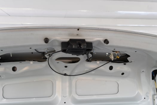 Vehicle maintenance action car trunk inspection automotive content indoor garage environment close-up viewpoint technical concept photo