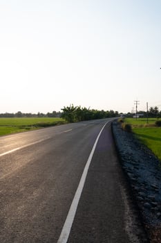 Scenic road journey rural landscape photograph open field eye-level tranquility and exploration photo