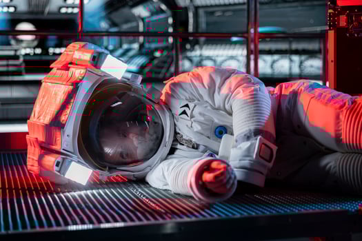 Space traveler lies motionless on floor, affected by low oxygen levels after critical systems shut down. Orbit station red light flashing and crew member passing out from environmental hazard photo