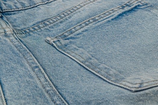 Close-up view of light blue denim fabric on pocket area photo