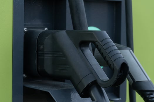 Electric Vehicle Charging Station Connectors with Handles and Green Panel photo