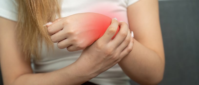 Wrist Pain Awareness. Young woman holding her wrist in discomfort. photo