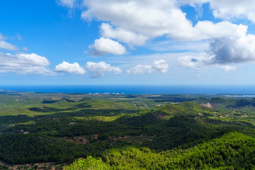 Discover the serene beauty of Mallorca, Spain, with a panoramic view of lush green hills leading to the coast. Experience the tranquil charm of Mallorca, Spain s idyllic landscapes. photo