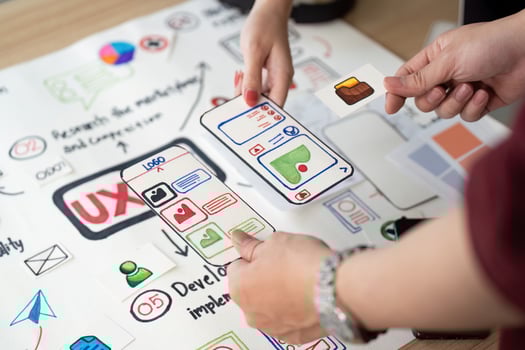 Collaborative UX Design. Team members discussing user interface elements on design board. photo