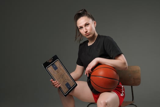 Female Basketball Coach with Clipboard and Ball, Confident Sports Strategy and Leadership Portrait photo