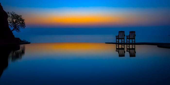 Two Chairs Sunset Reflection Calm Water Scenic View photo