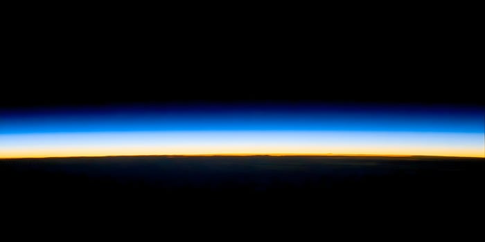 Earth Sunrise from Space Orange Yellow Blue Horizon Dark Background photo