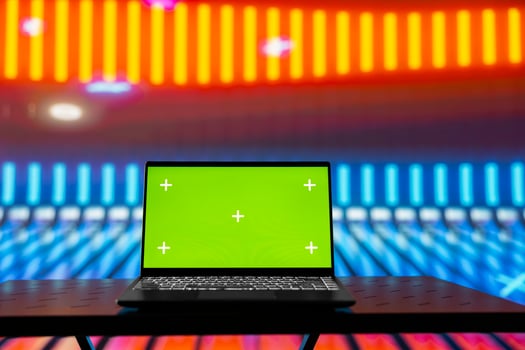 Empty glowing neon lit space with vivid colors and green screen display creates futuristic atmosphere for digital mockup, chroma key edits and artistic visual design in modern urban style. photo