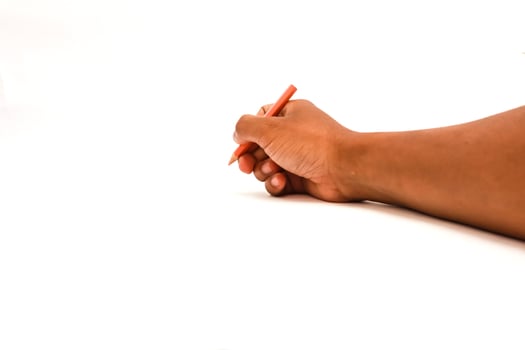 Hand holding a red pencil isolated on a white background represents creativity, writing and drawing concepts. photo