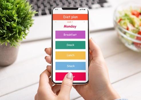 Weightloss and healthcare. Woman using diet plan application on cellphone screen, workplace background photo