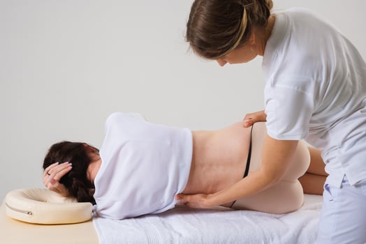 Rehabilitation Specialist Treating Woman with Spinal Curvature During Manual Therapy Session photo