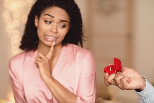 Relationship Breakup Concept. Black man making marriage proposal to young woman rejecting offer, frustrated girlfriend refuse to marry her boyfriend, not taking engagement ring, saying no, thinking photo