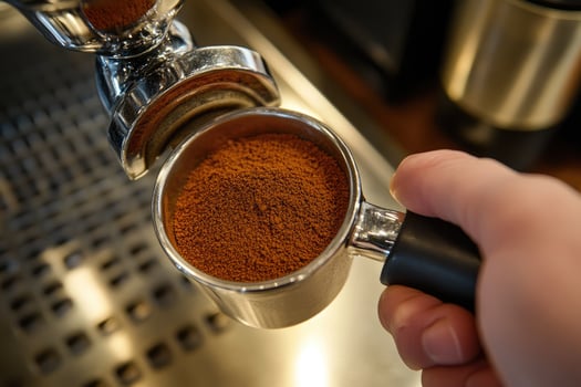 Ground coffee sits in a portafilter ready for espresso photo