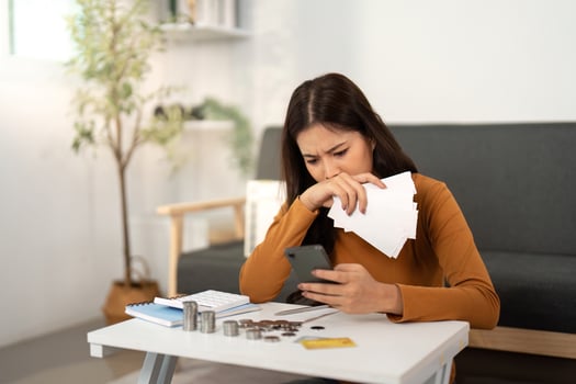 Financial Stress and Management. Woman feeling overwhelmed by expenses. photo