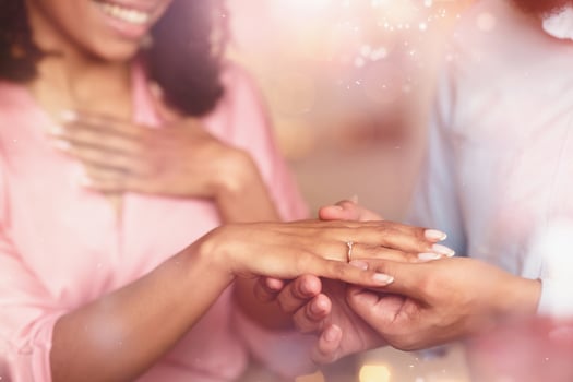 Proposal Concept. Closeup cropped view of unrecognizable young african american man in love putting wedding ring on his woman finger. Wedding, Marriage, Love And Relationship. photo