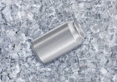 Aluminum soda can with water drops on ice cubes. Summer refreshing drink photo