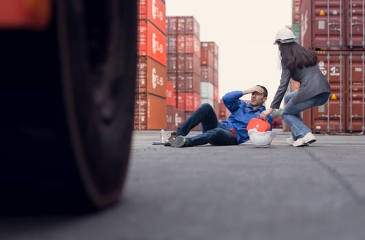 First aid for a container warehouse worker fainted while working in the bright sunlight and hot weather of a container storage yard,161 photo