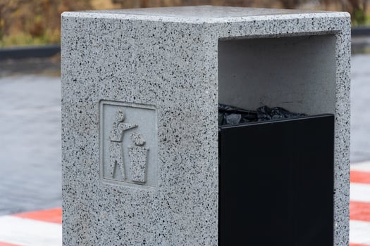 A modern concrete garbage container stands firm, encouraging responsible waste disposal and recycling photo