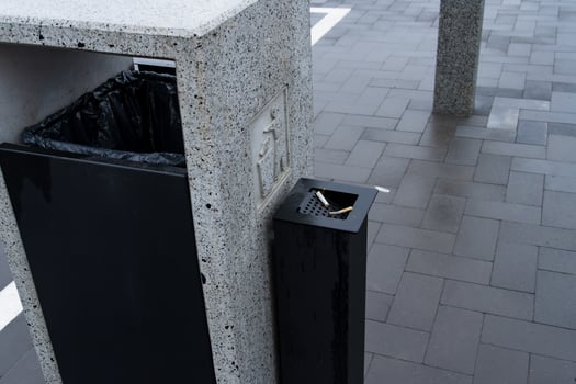 A sleek and contemporary garbage container stands in a bustling public area, designed to encourage responsible waste management photo