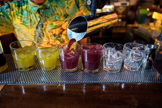 Bartender pouring Cocktail fruits in glass with ice photo