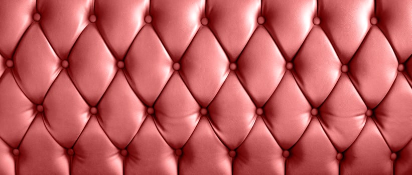 Vintage red leather sofa buttoned of textured background photo