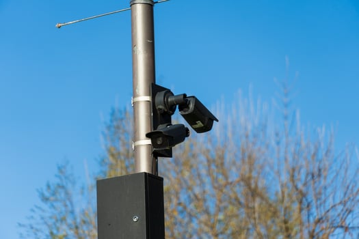 This setup features several CCTV cameras affixed to a pole, monitoring the surroundings in an effort to increase safety and security in a public space under bright daylight photo