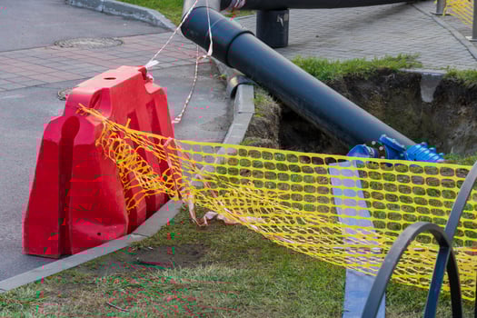 Workers are busy replacing old water pipes on a city street, involving significant excavation and the use of heavy equipment to ensure proper water supply infrastructure photo