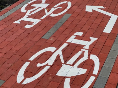 A well-maintained path features distinct bicycle lane designs, directing cyclists safely through a bustling city area, enhancing cycling accessibility photo