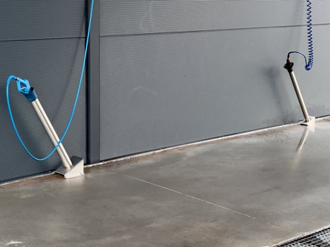 High-pressure washers are positioned for car cleaning, featuring hoses and nozzles, in a well-maintained car wash setting designed for efficient washing photo