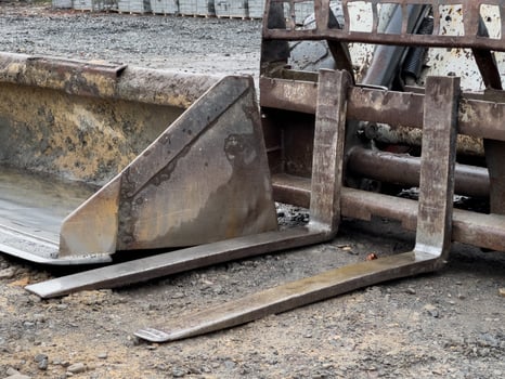 A bobcat bulldozer and a grader are positioned at a construction site, showcasing their heavy-duty machinery used for earthmoving and grading tasks photo