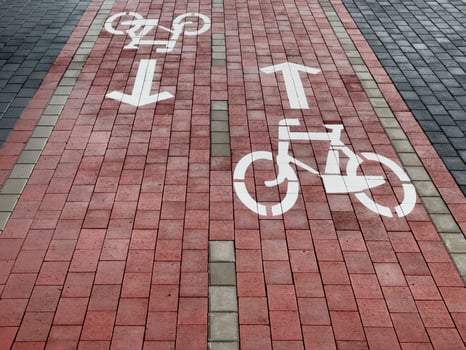 Clear bike lane signs indicate directional flow for cyclists, enhancing safety and organization on this urban pathway. The lanes are marked for efficient travel photo