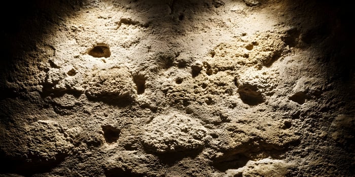 Rough Beige Stone Wall Texture Background Illuminated Spots photo