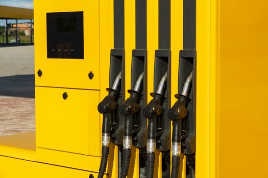 Gas station or a car filling station. Petrol pump filling nozzles at gas station photo