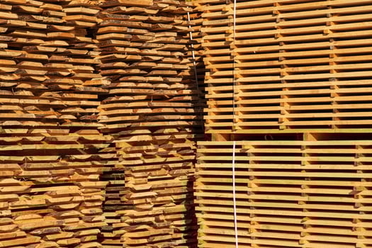 Wooden timber at a sawmill. Piles of wooden boards in the sawmill. Sawmill plant photo