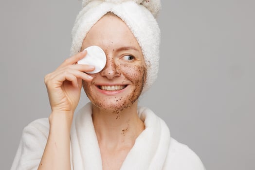 Woman Smiling with Cotton Pad Removing Face Scrub, Skin Care, Exfoliation, Clean Beauty Routine photo