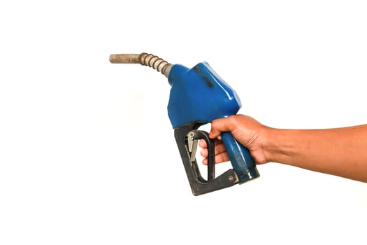 Human Hand Holding a Blue Fuel Nozzle Isolated on a White Background for Filling Fuel photo
