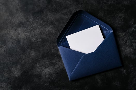 Elegant Navy Envelope With Blank Card on Black Surface. photo